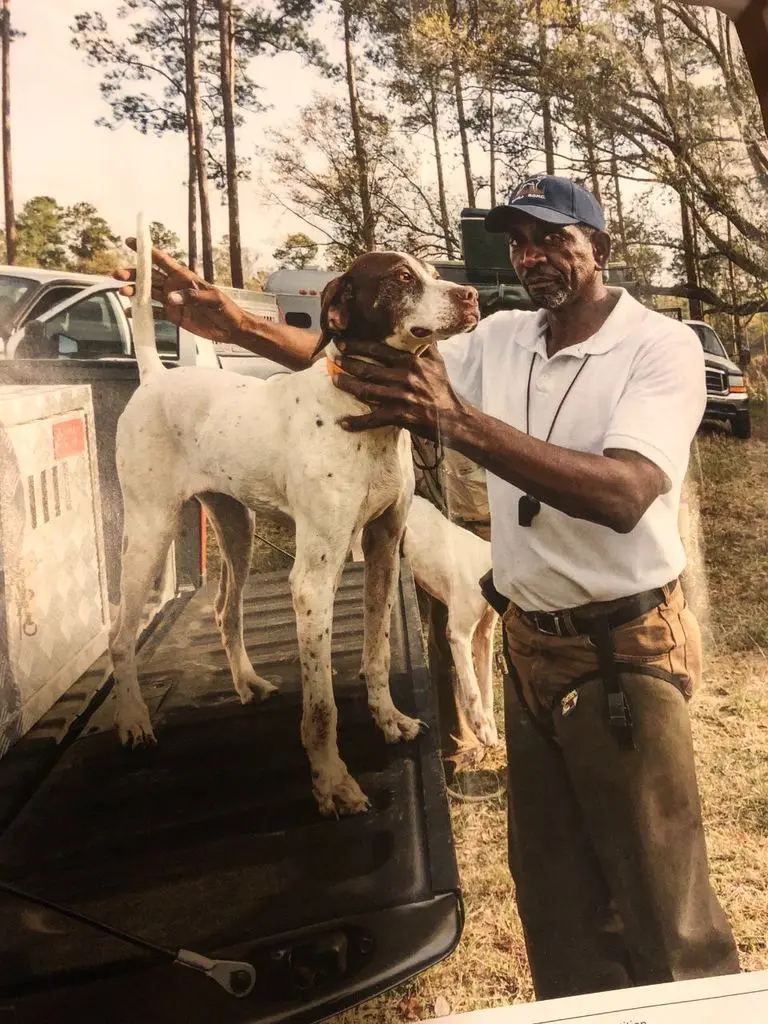 Magazine page — mentor styling a pointer on the tailgate