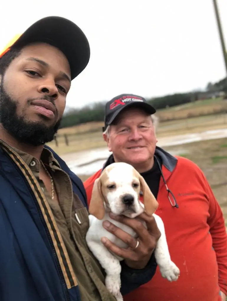 Picking up the pointer puppy from the breeder