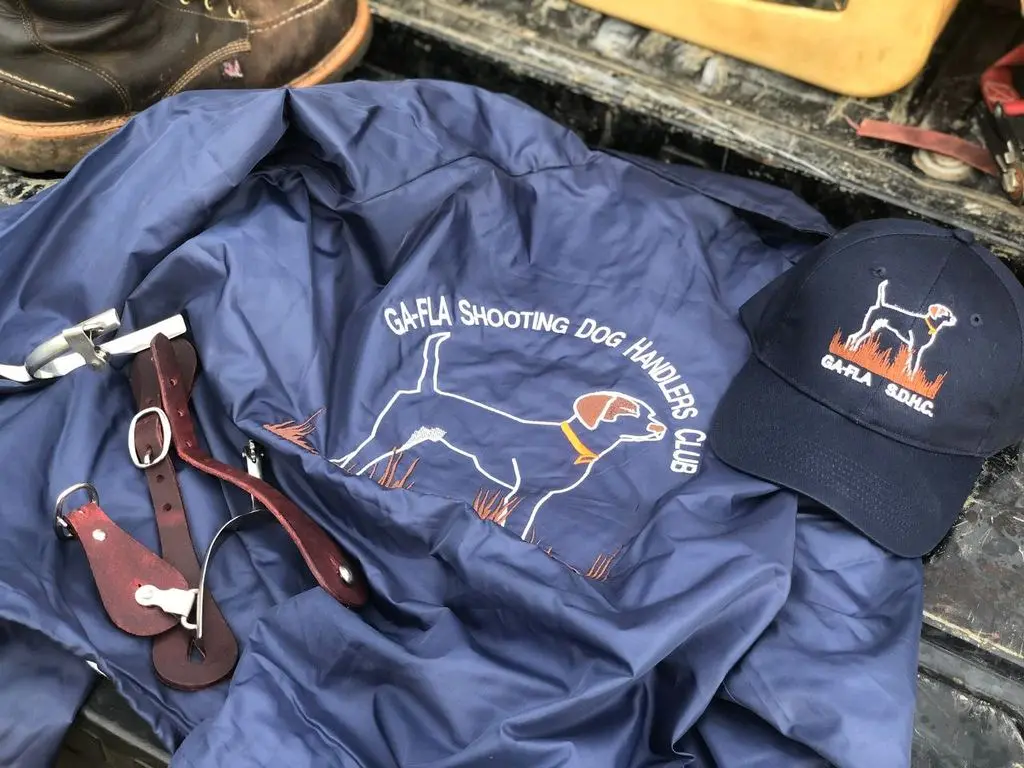 Club jacket, cap, and spurs laid out on the tailgate