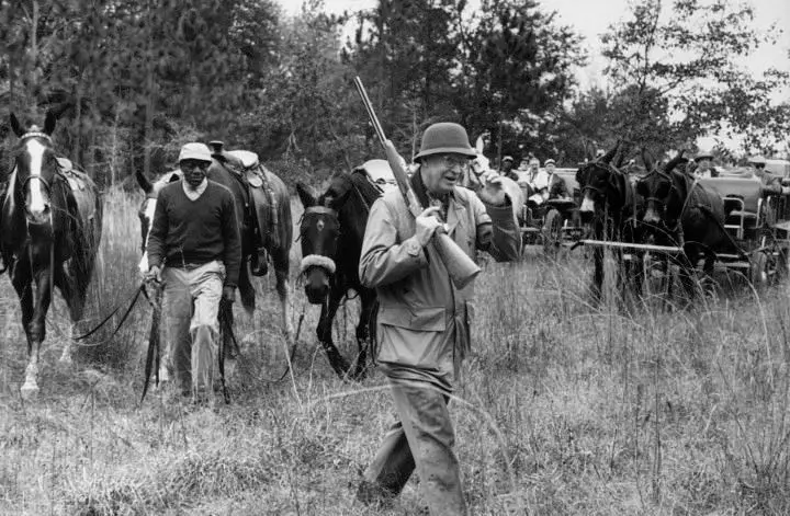 A young outrider and a hunter on a quail wagon